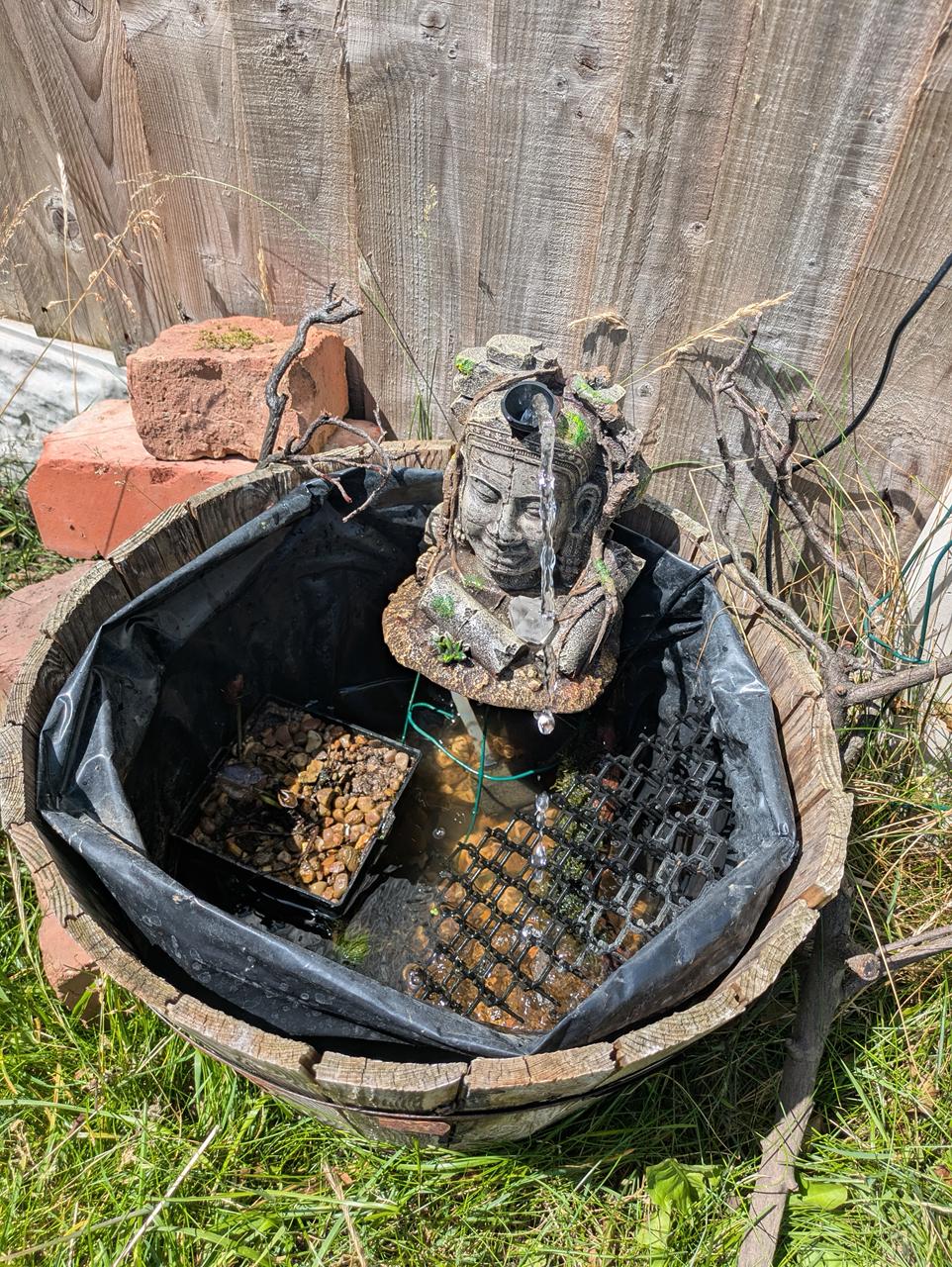 The sabotaged pond with pulled-up lining and low water level